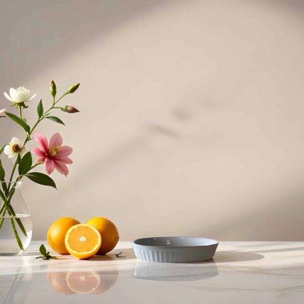 vase with flowers and lemons on a table, with a plate in a softly lit room.